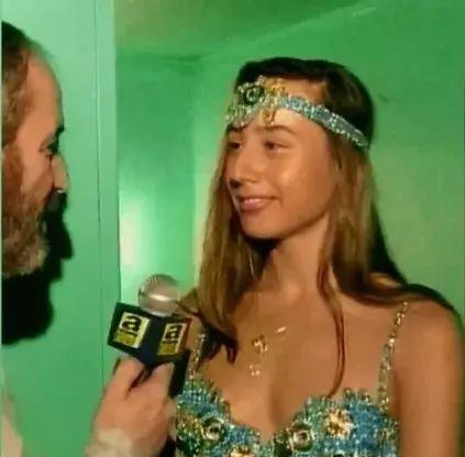 Asena speaking about her childhood experiences on a TV program