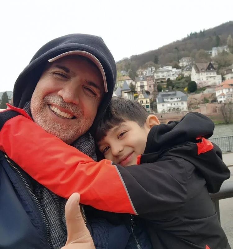 Ozcan Deniz and son Kuzey looking alike in holiday photos
